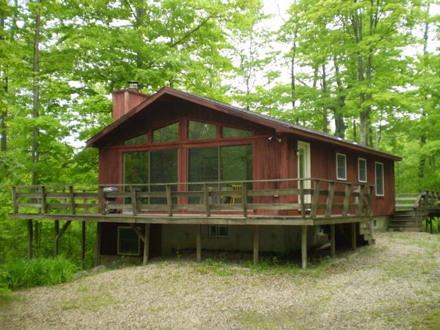 49 Stebbins Road Otis, MA 01253 - Photo 1 of 8 a front view of a house with a garden