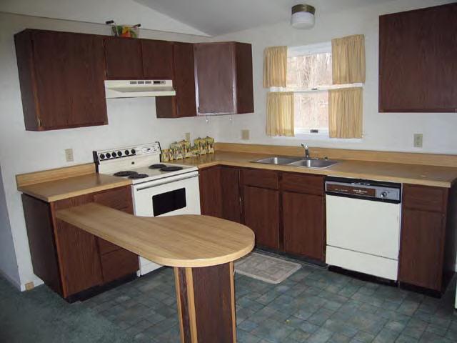 49 Stebbins Road Otis, MA 01253 - Photo 5 of 8 a kitchen with a sink a stove a counter space and cabinets