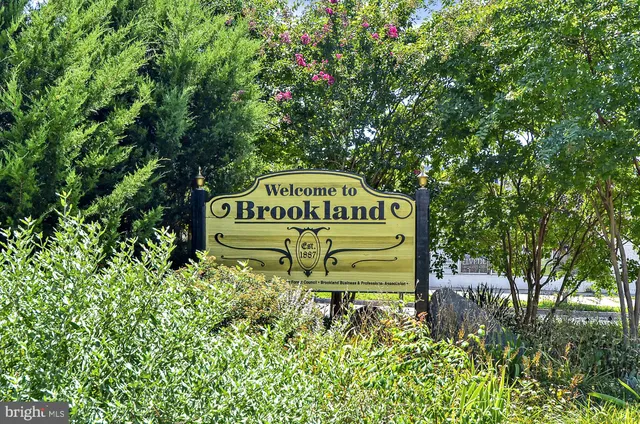 a wooden bench sitting in front of a building