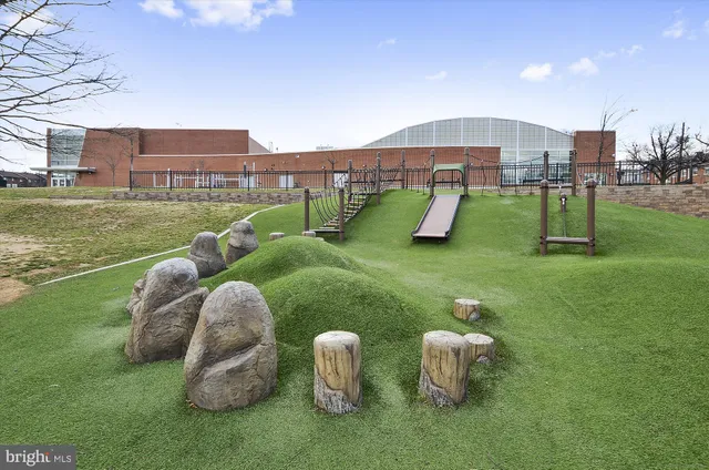 a view of a cars park in front of a building