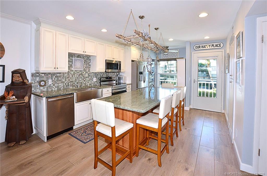 1864 Southwest Palm City Road, Unit 204 Stuart, FL 34994 - Photo 11 of 42 WIDE OPEN KITCHEN, LOADS OF STORAGE IN THE ISLAND THAT ALSO SEATS 5!