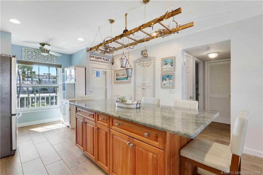 1864 Southwest Palm City Road, Unit 204 Stuart, FL 34994 - Photo 25 of 42 ISLAND IN KITCHEN SEATS 5 AND HAS LOADS OF STORAGE