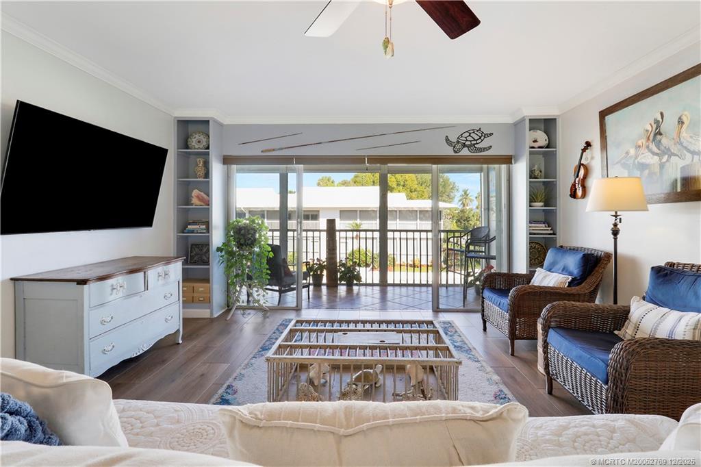 1864 Southwest Palm City Road, Unit 204 Stuart, FL 34994 - Photo 26 of 42 LIVING ROOM HAS A WALL OF SLIDERS THAT OPEN TO THE 25' LONG SCREENED LANAI