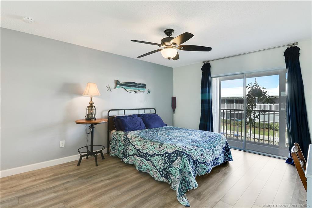 1864 Southwest Palm City Road, Unit 204 Stuart, FL 34994 - Photo 31 of 42 MAIN BEDROOM WITH SLIDERS TO THE 25' SCREENED LANAI