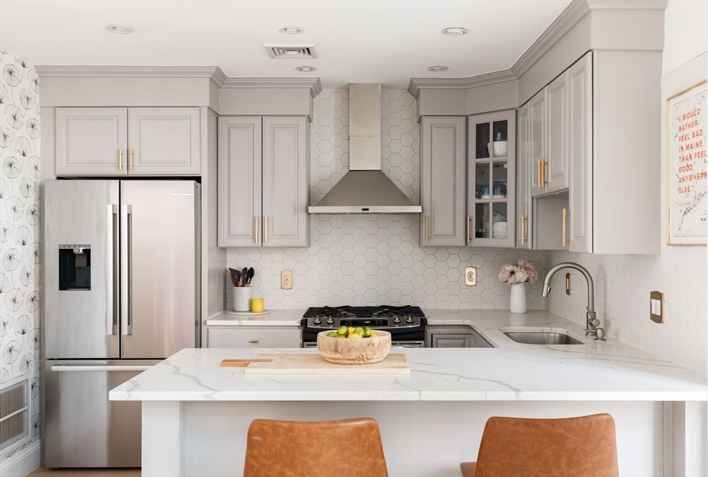 20 Mystic Street, Unit 2 Boston, MA 02129 - Photo 4 of 15 a kitchen with stainless steel appliances a sink stove and refrigerator