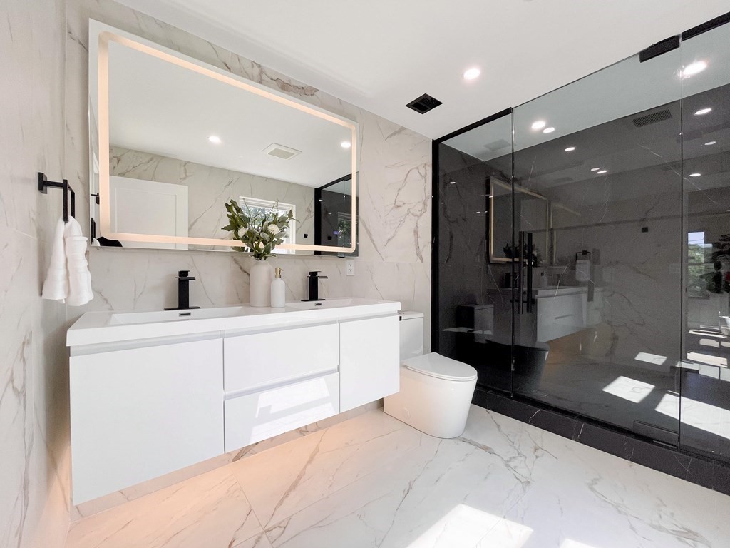 17 Gayland Road Needham, MA 02492 - Photo 12 of 33 a bathroom with a sink a toilet and a mirror