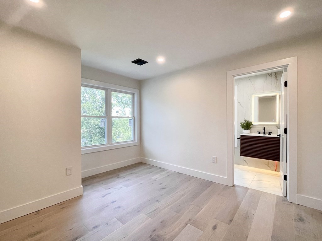 17 Gayland Road Needham, MA 02492 - Photo 23 of 33 an empty room with wooden floor and windows