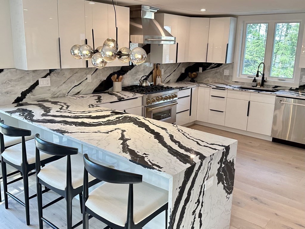 17 Gayland Road Needham, MA 02492 - Photo 8 of 33 a kitchen with a table chairs sink and cabinets
