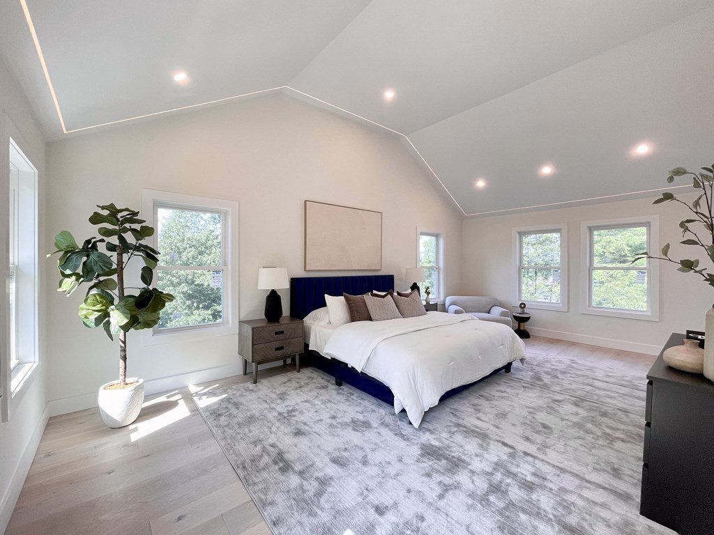 17 Gayland Road Needham, MA 02492 - Photo 10 of 33 a spacious bedroom with a large bed and a potted plant