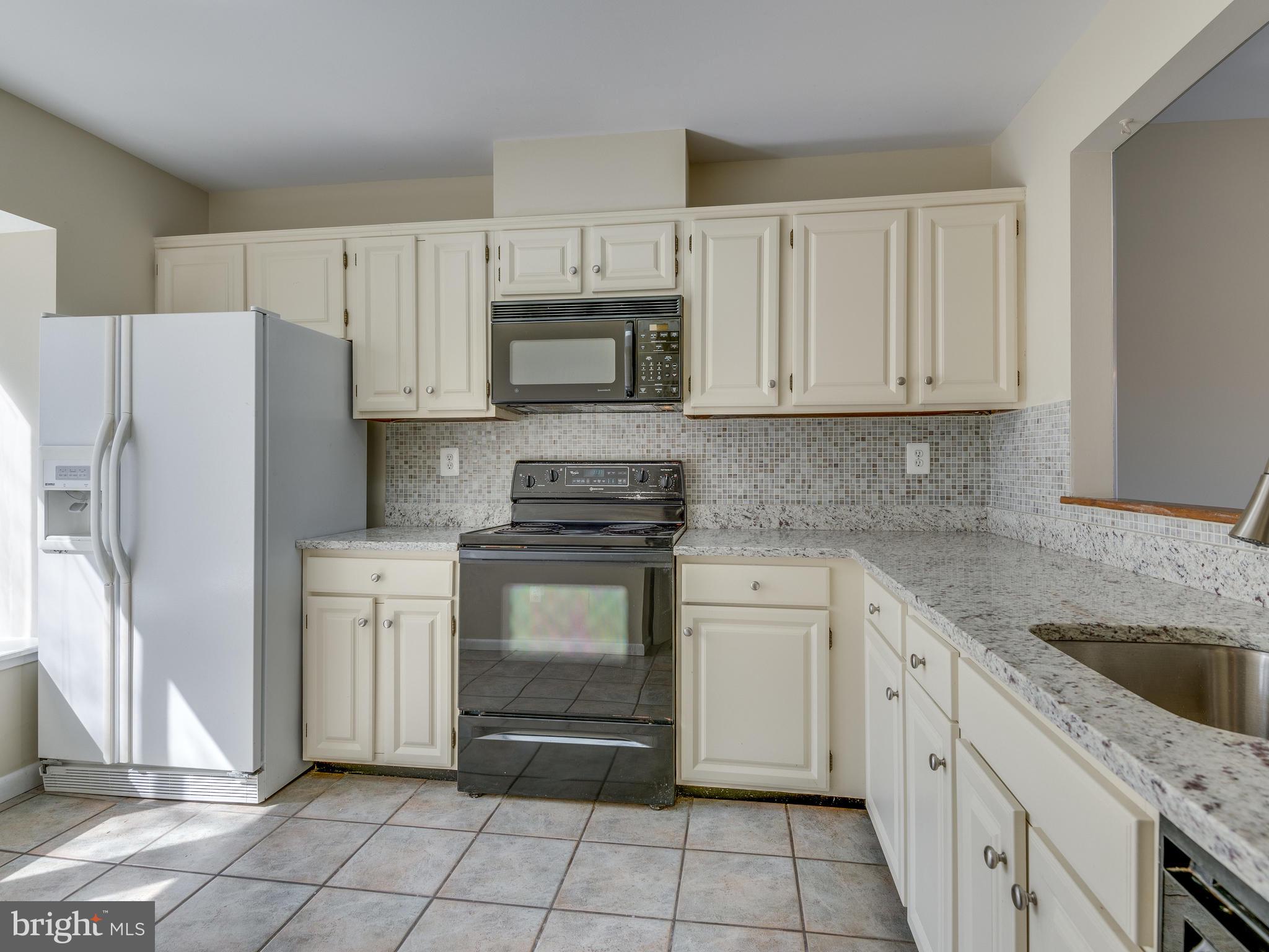 2017 Chadds Ford Drive Reston, VA 20191 - Photo 5 of 32 Granite countertops and tile backsplash