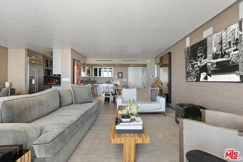a living room with furniture a dining table and kitchen view