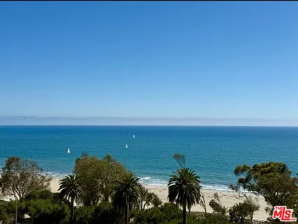 a living room with furniture a dining table and a chandelier