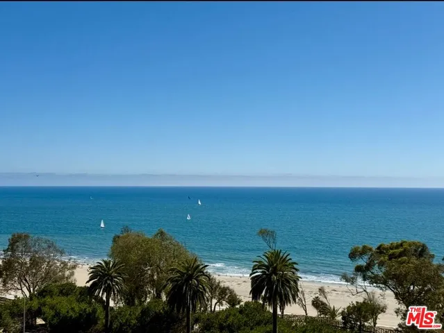 a living room with furniture a dining table and a chandelier