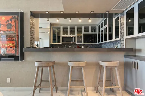 a large kitchen with stainless steel appliances granite countertop a refrigerator and a sink