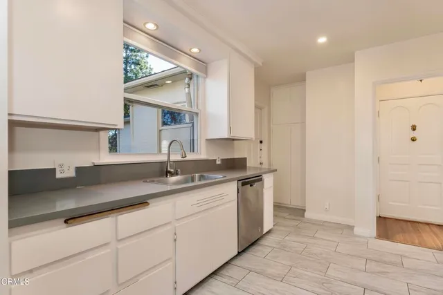 a kitchen with a sink and cabinets