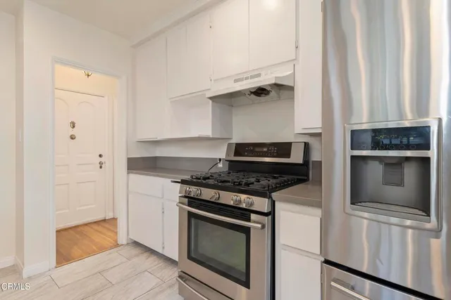 a kitchen with cabinets and steel stainless steel appliances