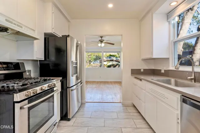 a kitchen with a stove a refrigerator and a sink