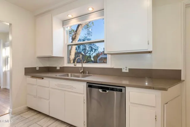 a kitchen with a sink and cabinets