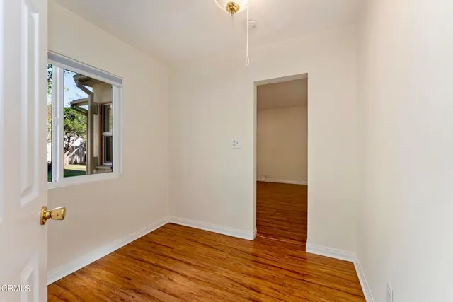 a view of hallway with wooden floor and front door