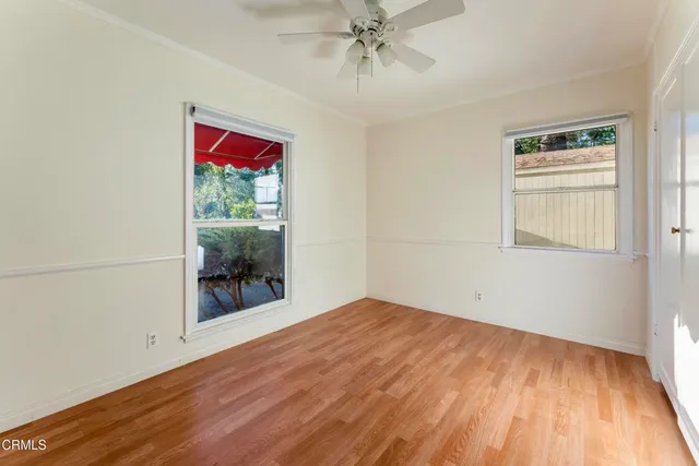 wooden floor in an empty room with a window