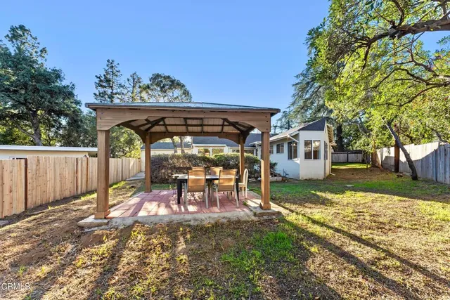 a view of a house with backyard porch and sitting area