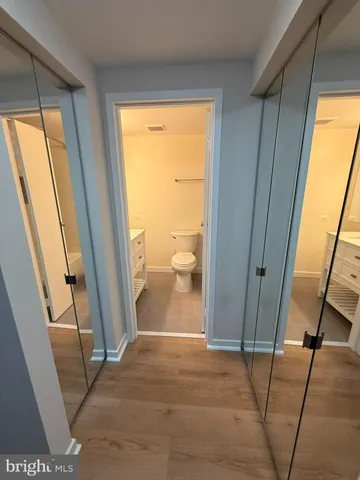 a bathroom with a sink a toilet and mirror