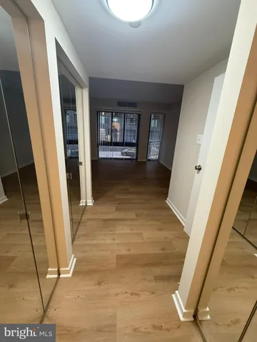a view of an empty room with glass door