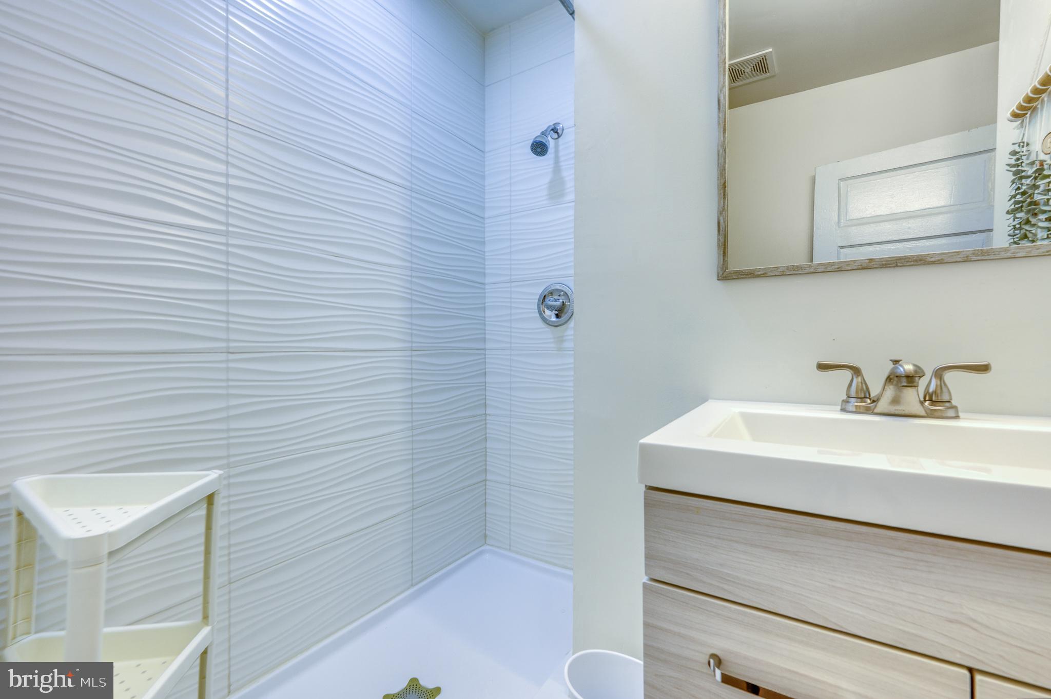 7104 Harford Road Baltimore, MD 21234 - Photo 20 of 37 a bathroom with a sink a toilet and shower