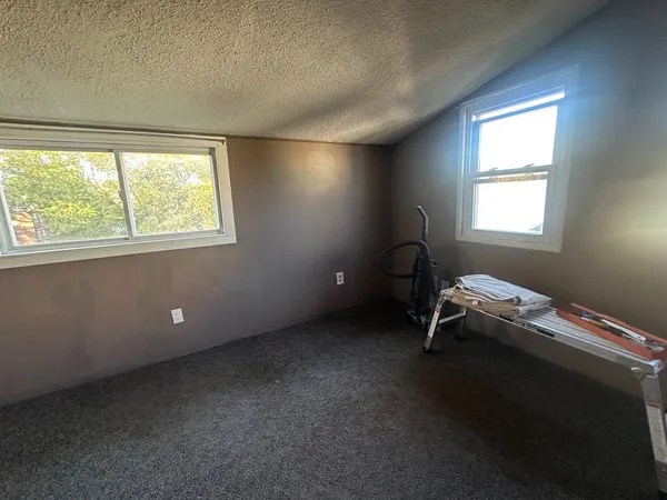 a room with a bed and a window