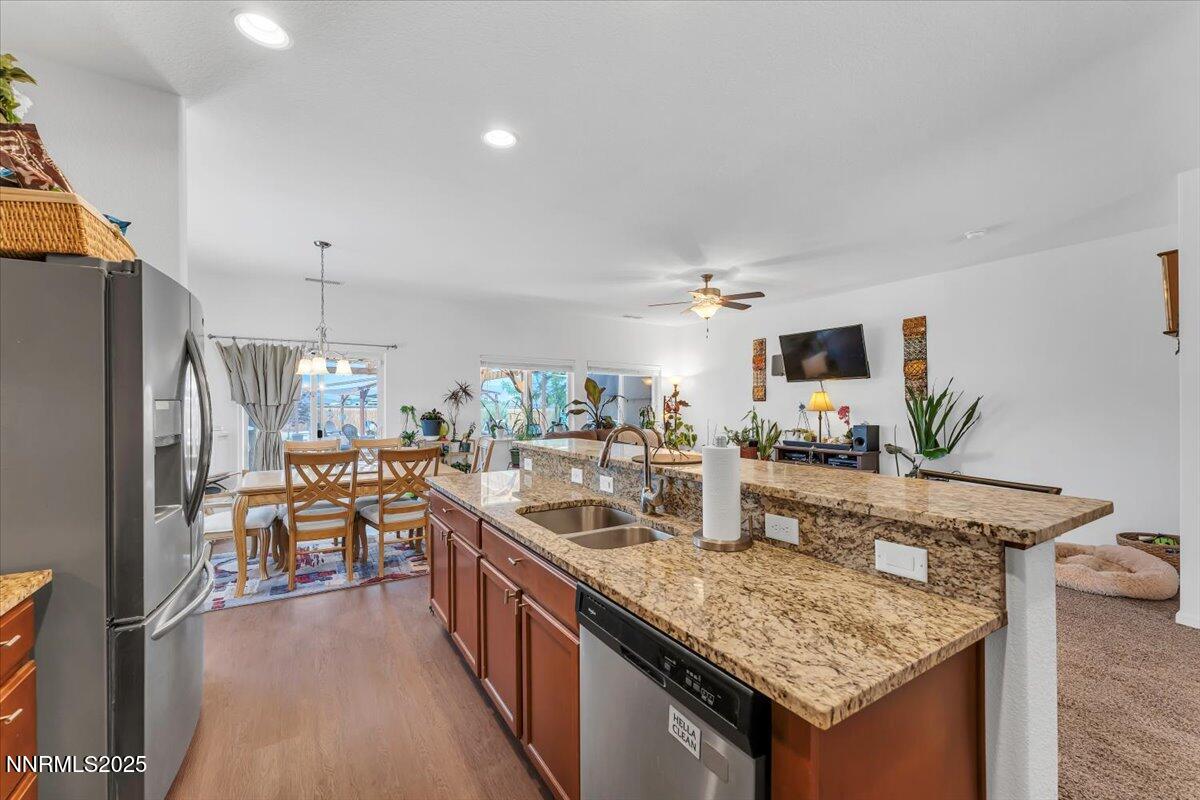 1178 Jasmine Lane Fernley, NV 89408 - Photo 14 of 65 a kitchen with granite countertop a sink stove and refrigerator
