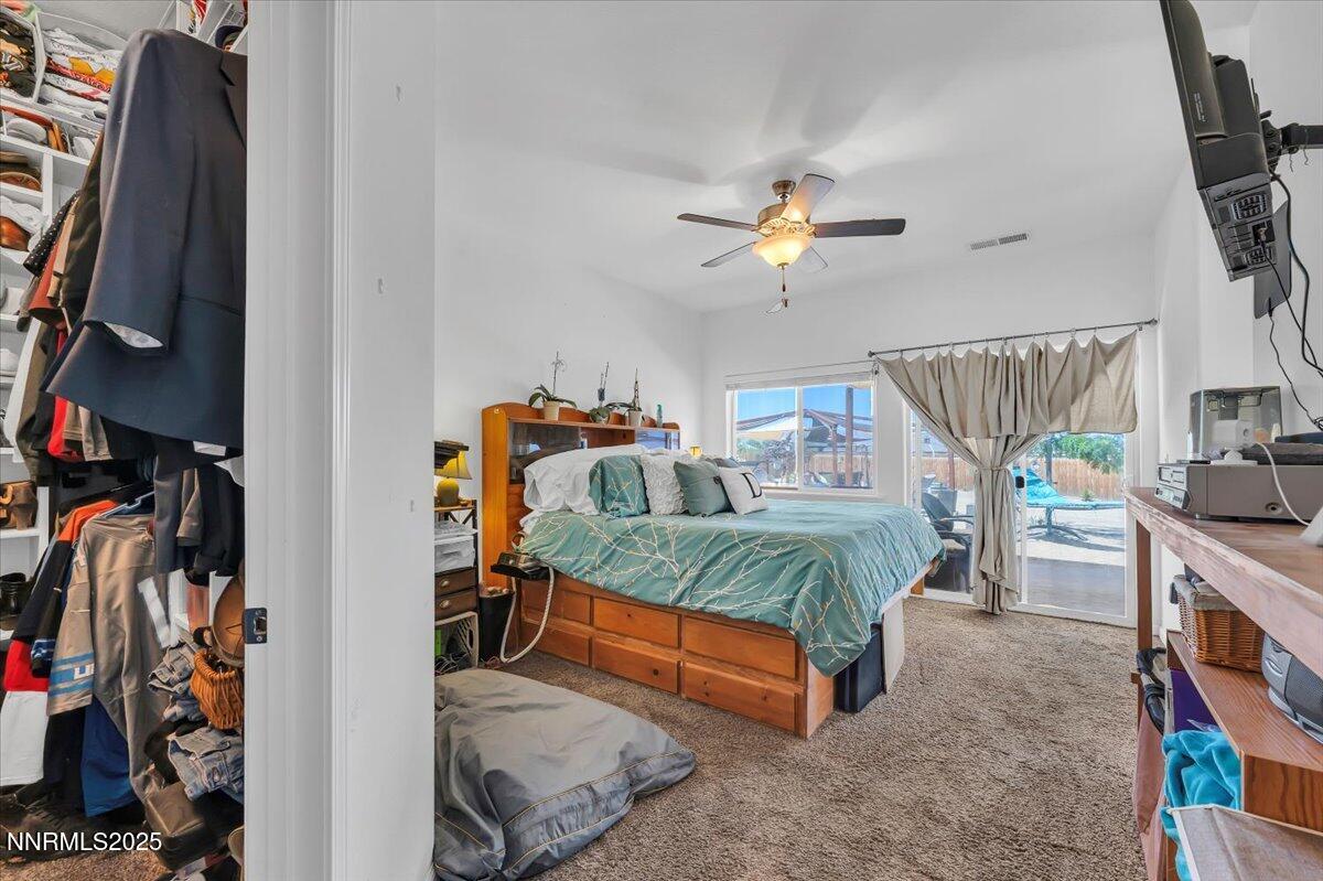 1178 Jasmine Lane Fernley, NV 89408 - Photo 16 of 65 a bedroom with bed and a chandelier