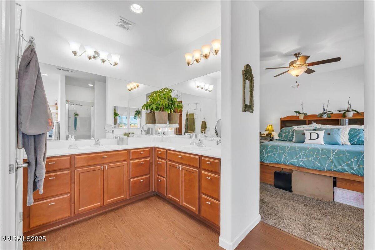 1178 Jasmine Lane Fernley, NV 89408 - Photo 19 of 65 a spacious bathroom with a granite countertop sink a mirror and shower