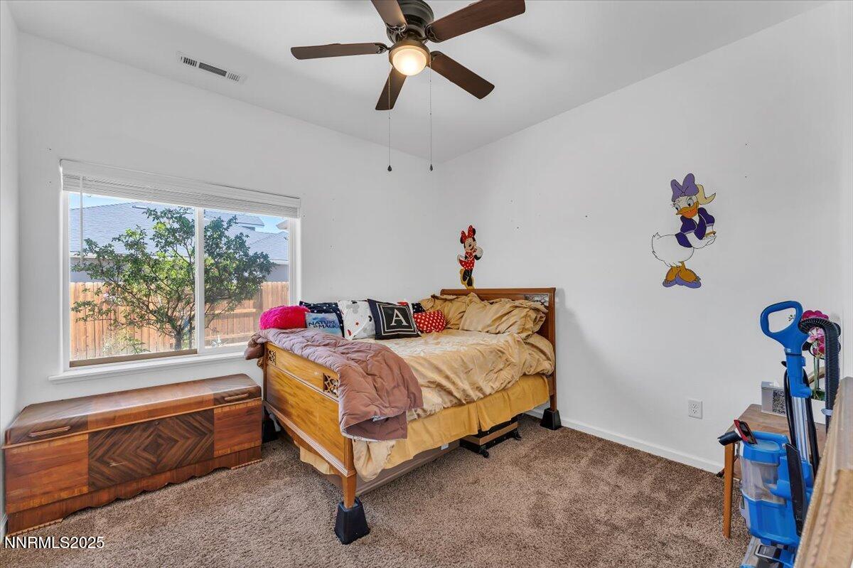 1178 Jasmine Lane Fernley, NV 89408 - Photo 21 of 65 a room with a bed and a window