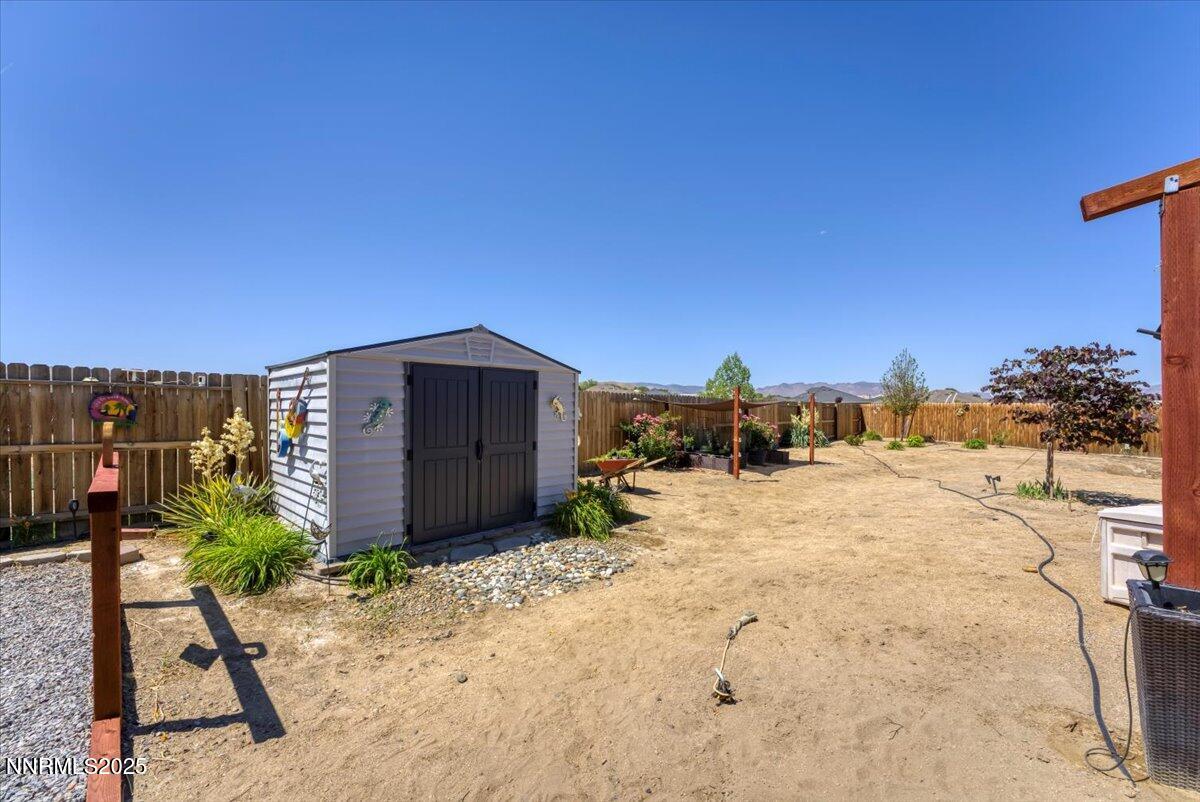 1178 Jasmine Lane Fernley, NV 89408 - Photo 29 of 65 a view of a dry yard with a building in the background