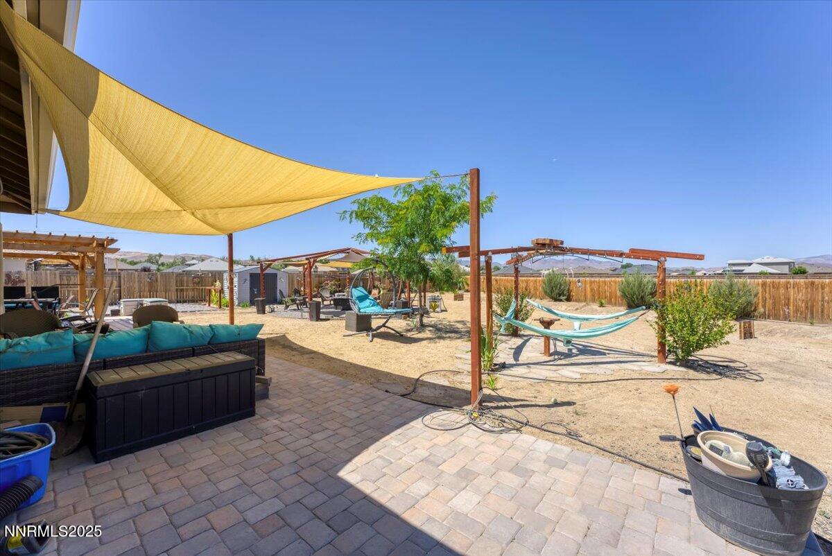 1178 Jasmine Lane Fernley, NV 89408 - Photo 35 of 65 a view of a patio with couches and chairs under an umbrella