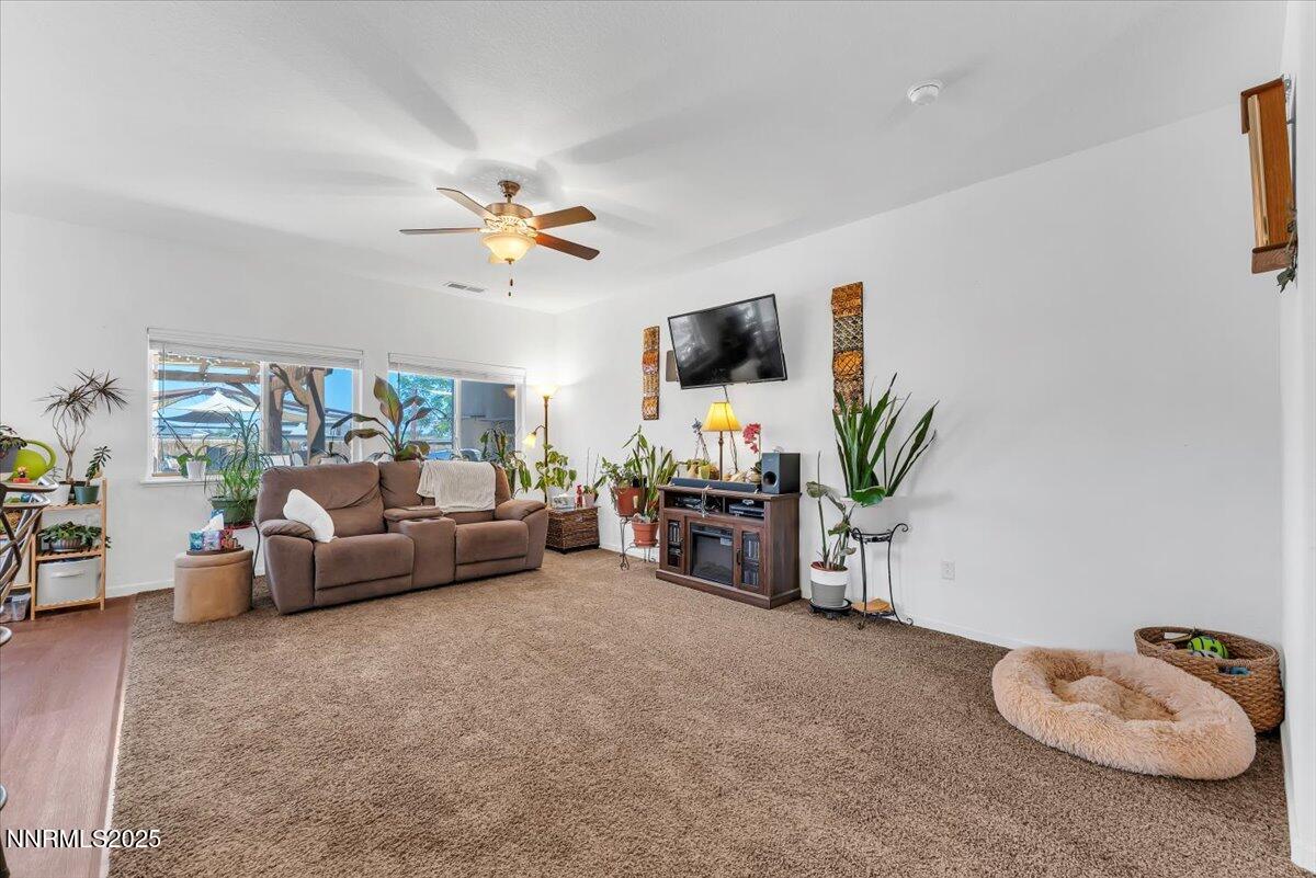 1178 Jasmine Lane Fernley, NV 89408 - Photo 6 of 65 a living room with furniture and a flat screen tv