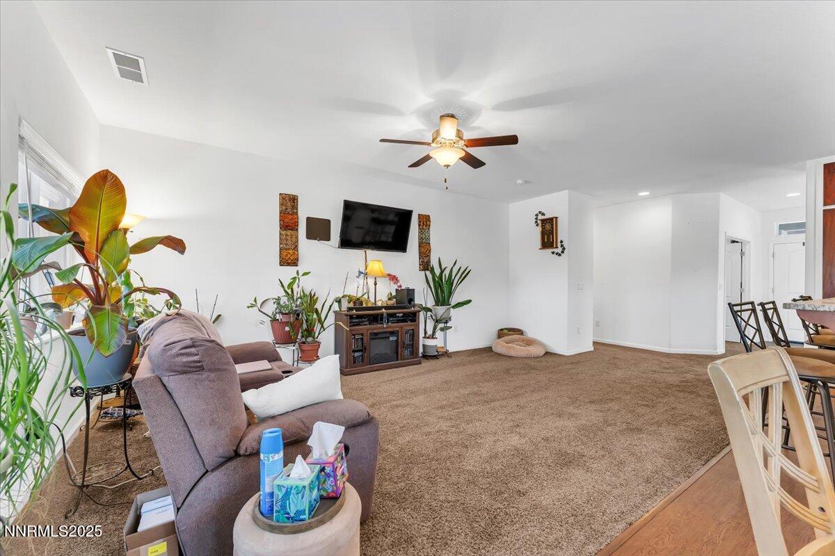 1178 Jasmine Lane Fernley, NV 89408 - Photo 7 of 65 a living room with furniture a couch and a chandelier