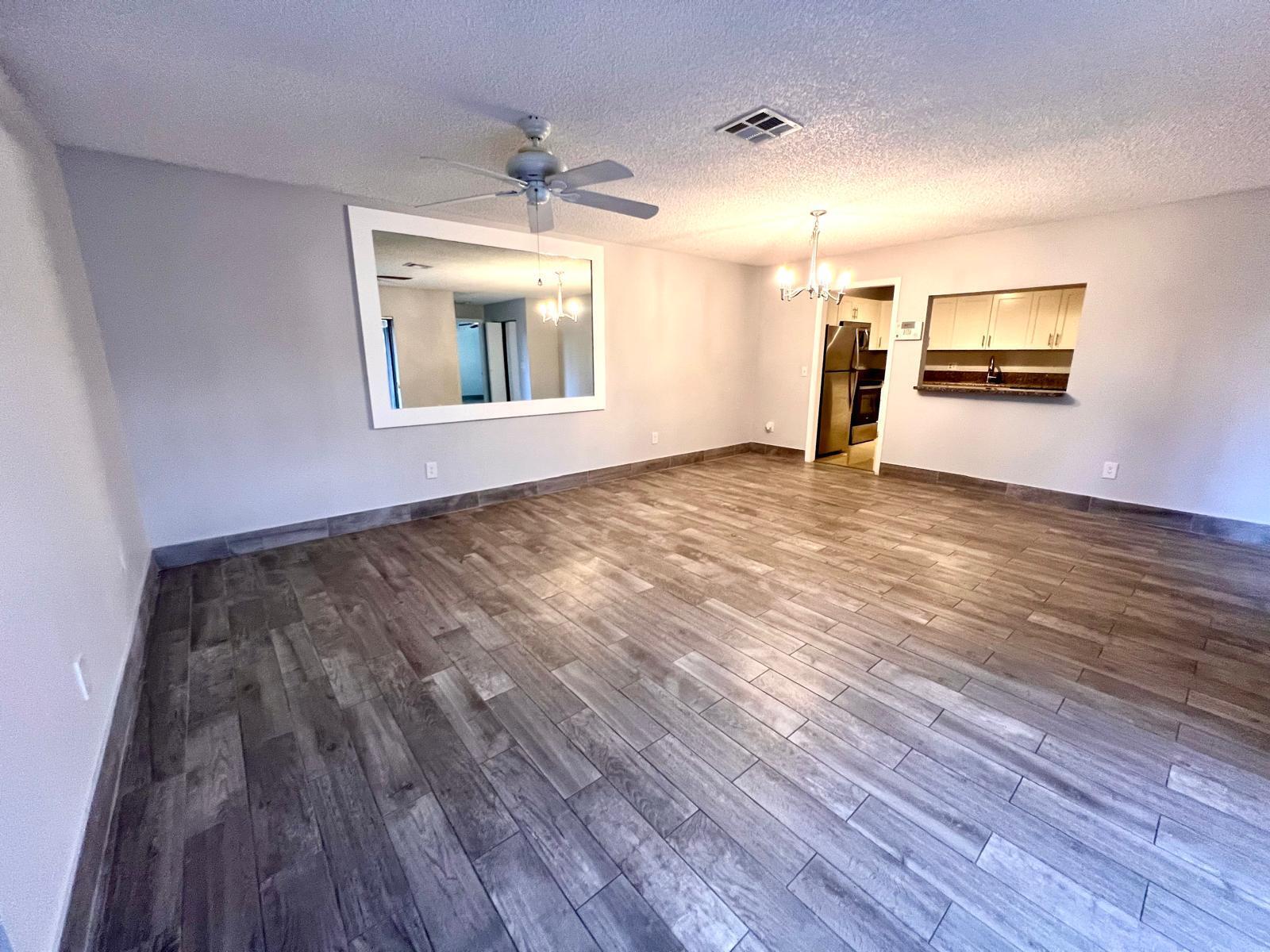 8113 Ambach Way, Unit 28A Hypoluxo, FL 33462 - Photo 1 of 20 a view of empty room with wooden floor