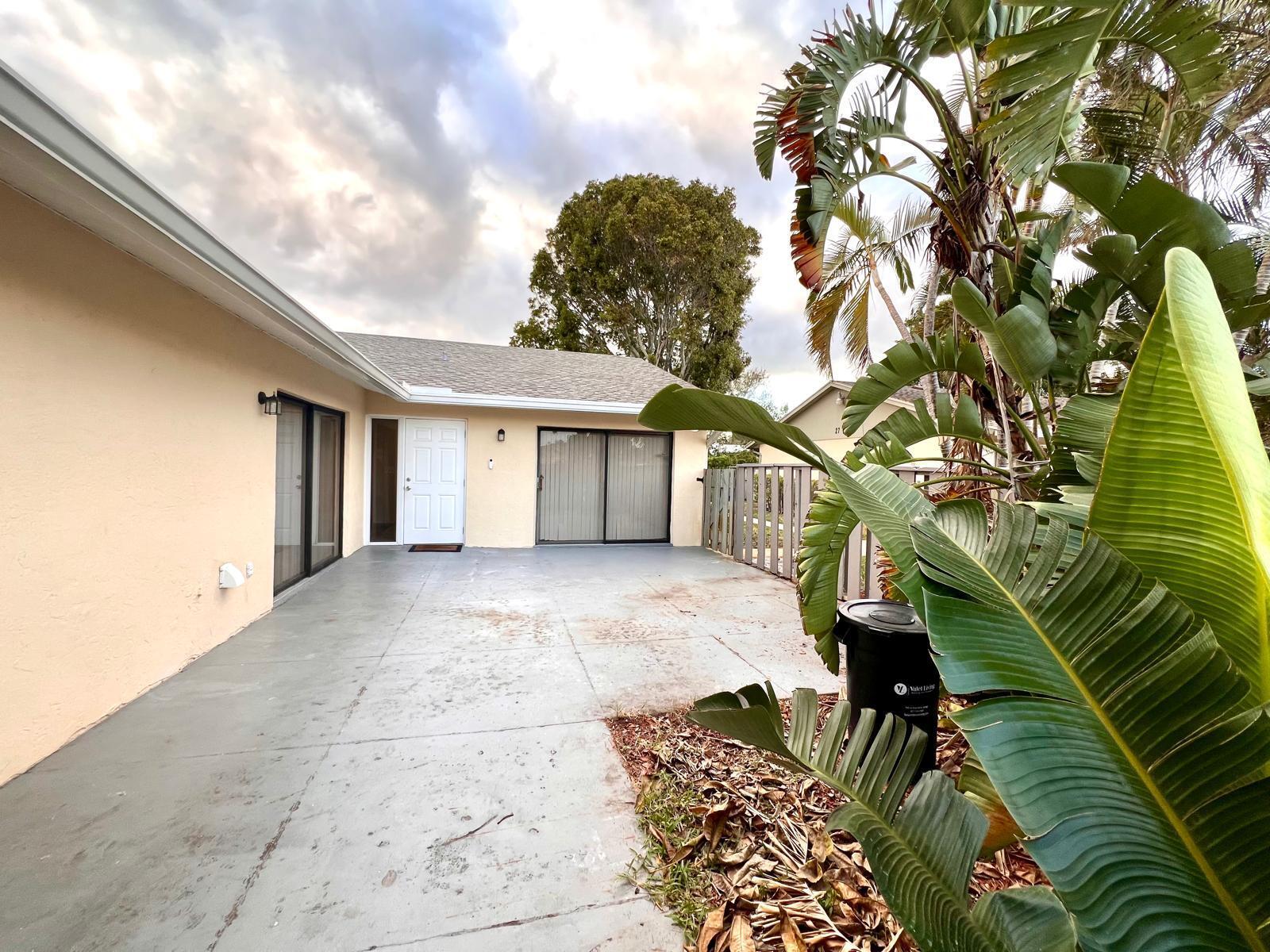 8113 Ambach Way, Unit 28A Hypoluxo, FL 33462 - Photo 17 of 20 a view of backyard with green space