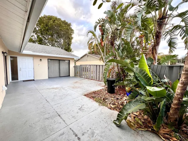 a view of backyard with a garden and trees