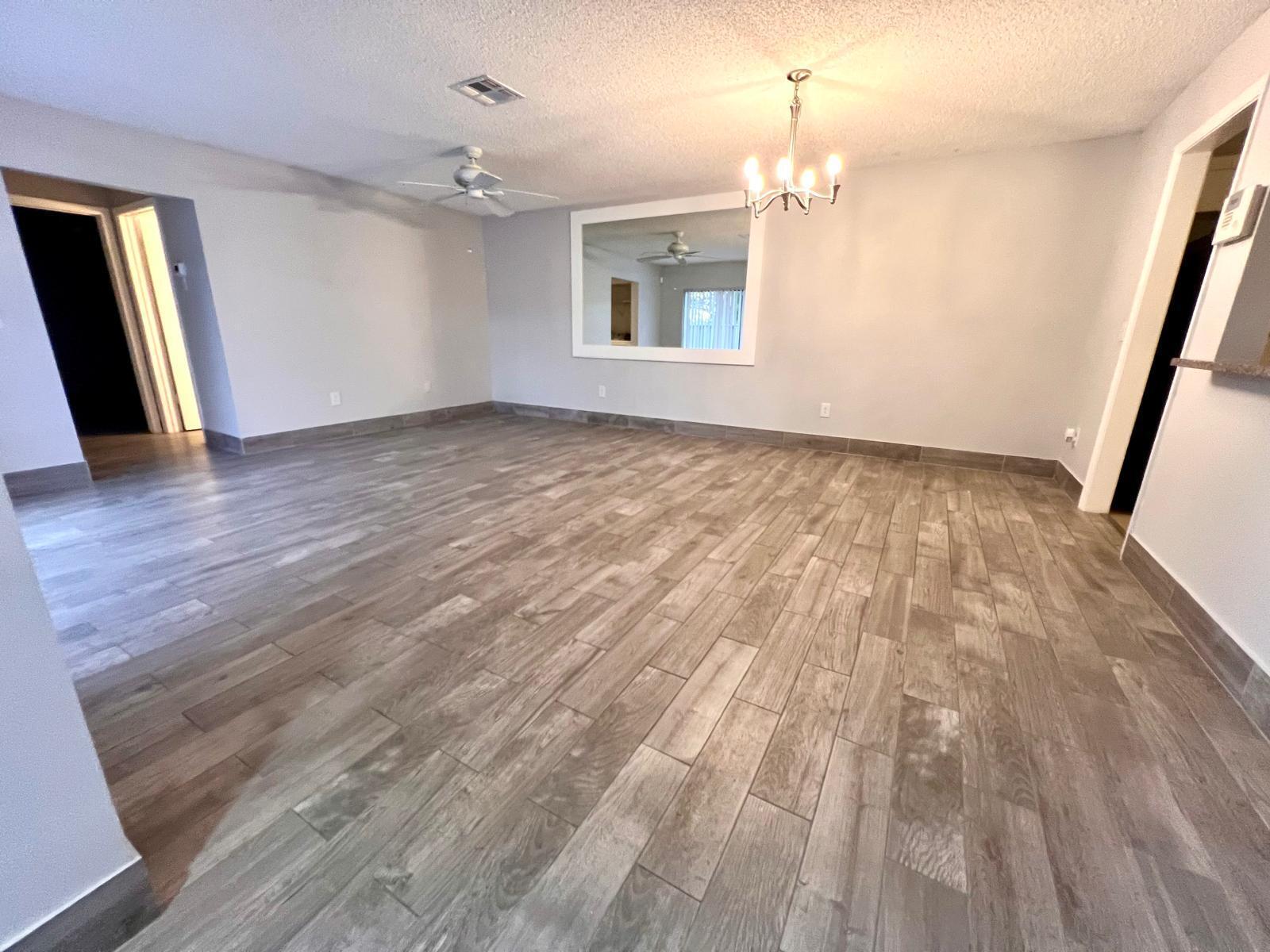 8113 Ambach Way, Unit 28A Hypoluxo, FL 33462 - Photo 4 of 20 wooden floor in an empty room with a window
