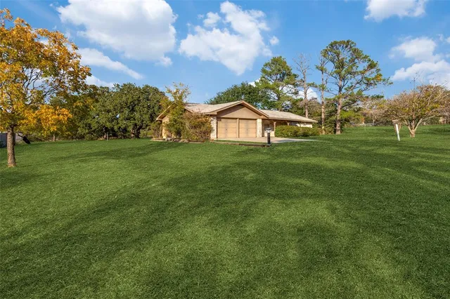 a front view of a house with a garden and plants