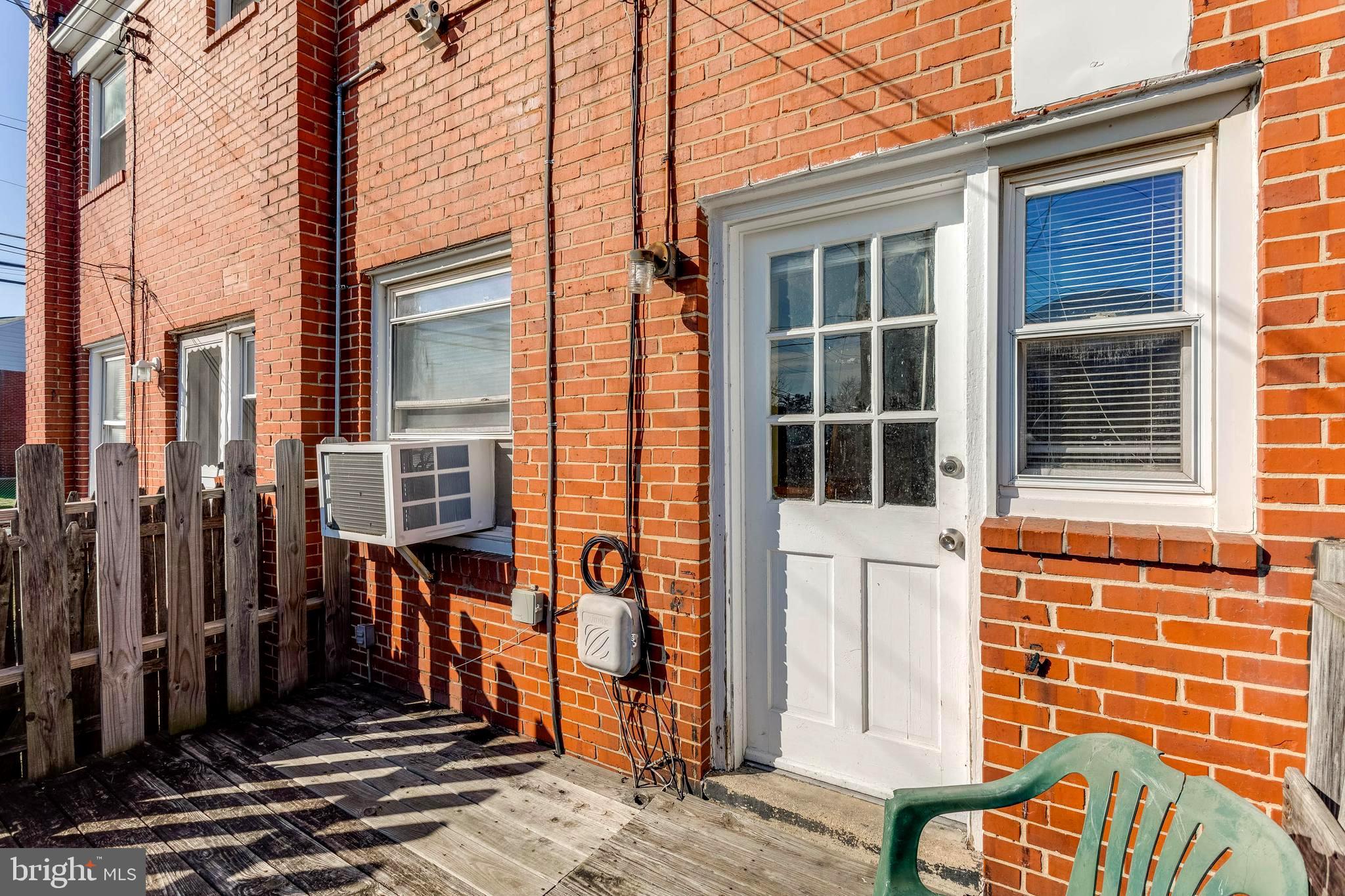 1919 Larkhall Road Dundalk, MD 21222 - Photo 22 of 23 a view of a brick house with many windows