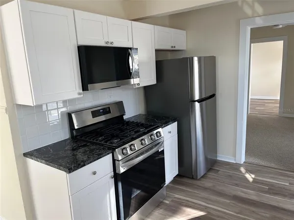 a kitchen with a stove microwave and refrigerator