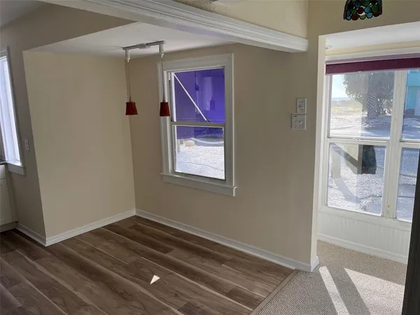 a view of a room with a windows and a ceiling fan