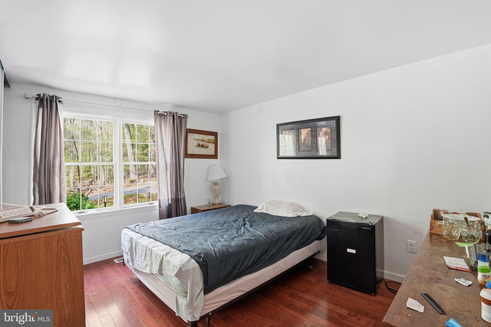 17107 Overhill Road Rockville, MD 20855 - Photo 16 of 37 a living room with a bed and a window