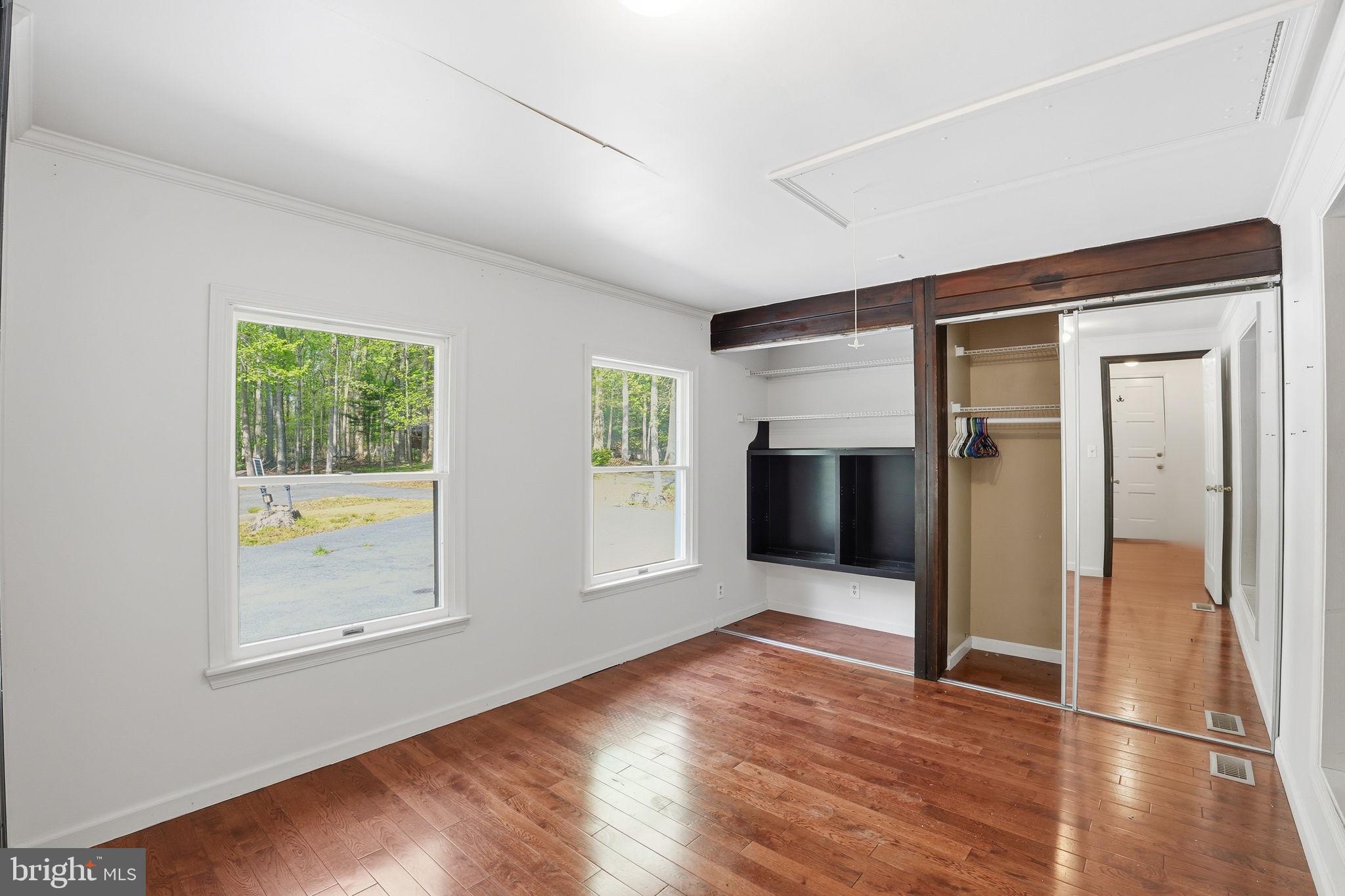 17107 Overhill Road Rockville, MD 20855 - Photo 17 of 37 a view of an empty room with wooden floor and a window