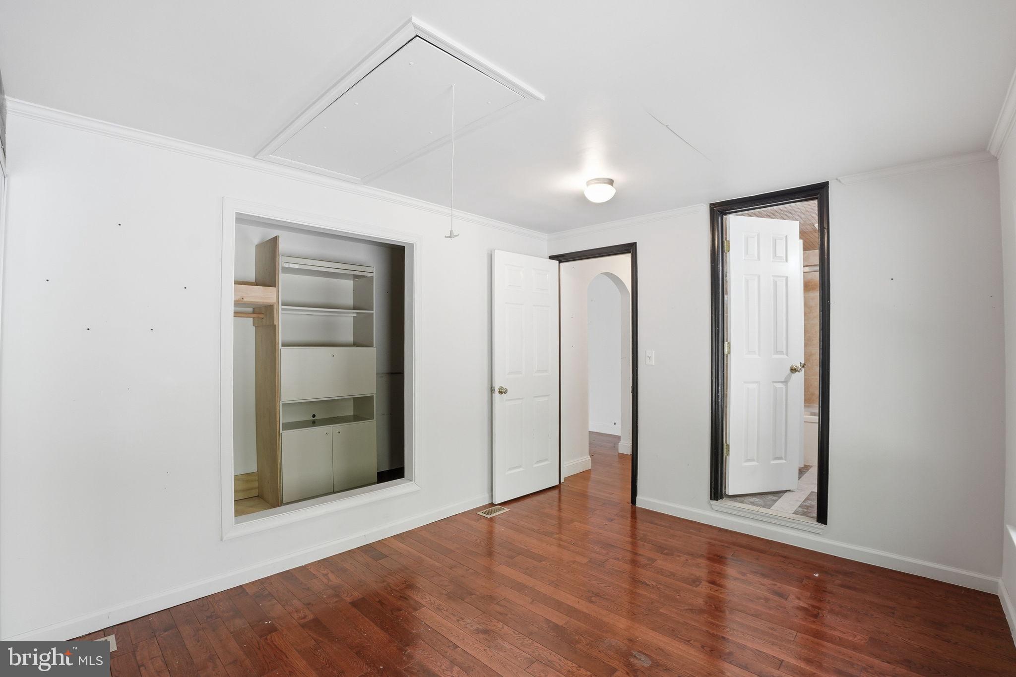 17107 Overhill Road Rockville, MD 20855 - Photo 18 of 37 an empty room with closet and wooden floor