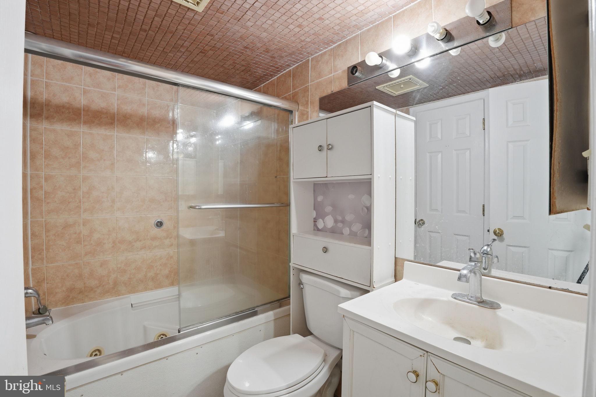 17107 Overhill Road Rockville, MD 20855 - Photo 22 of 37 a bathroom with a sink toilet and shower