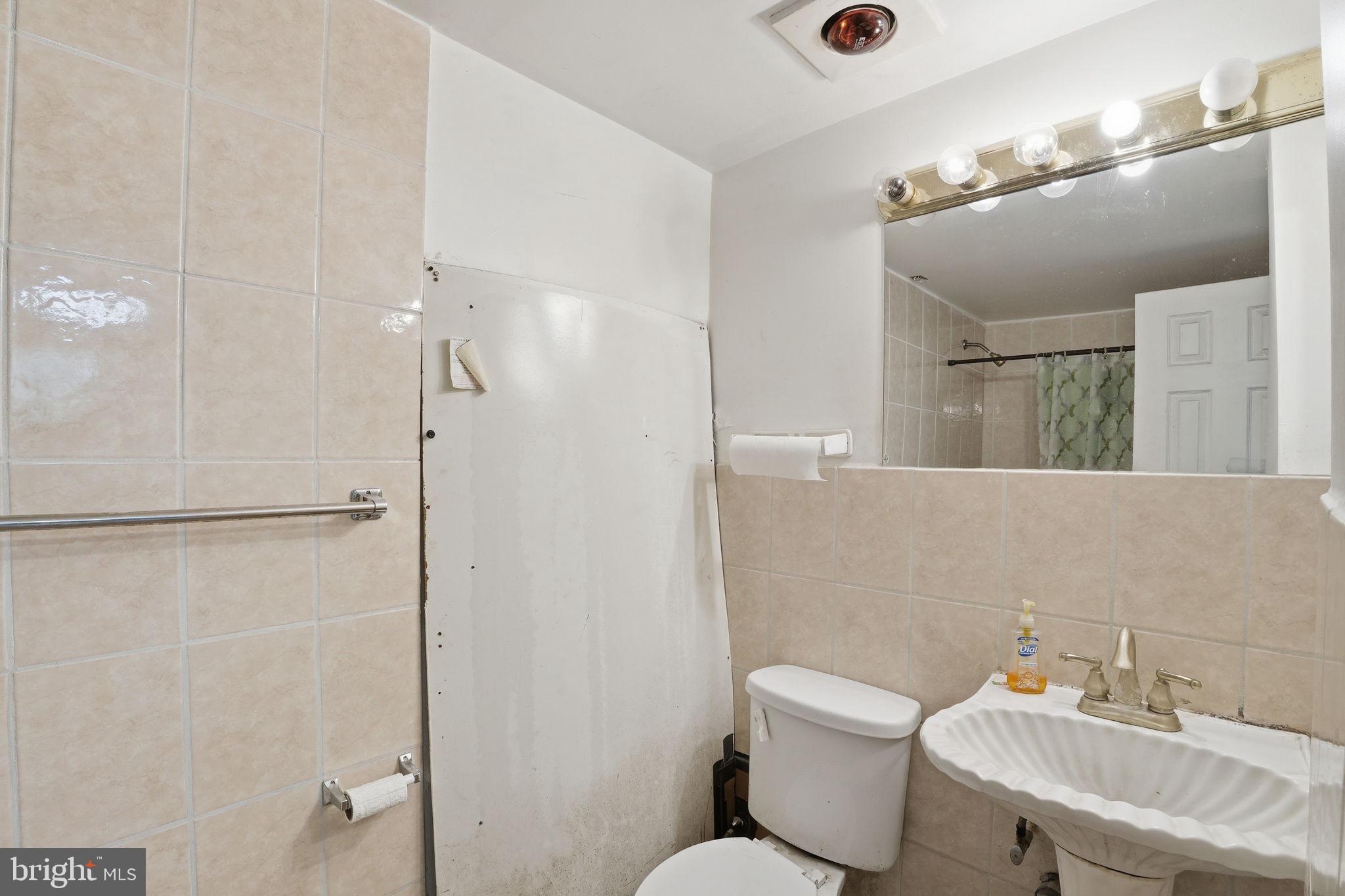17107 Overhill Road Rockville, MD 20855 - Photo 24 of 37 a bathroom with a toilet sink and shower